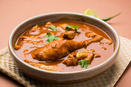 Indian spicy Chicken curry or masala chicken with prominent leg piece, popular recipe from India, selective focusの写真素材