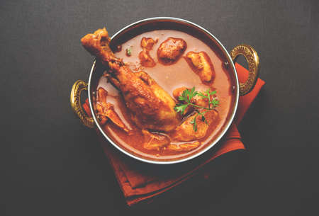 Indian spicy Chicken curry or masala chicken with prominent leg piece, popular recipe from India, selective focusの写真素材