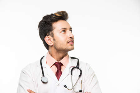 Portrait of an cheerful Indian handsome male doctor with a stethoscope around his neck, isolated over white background, selective focusの写真素材