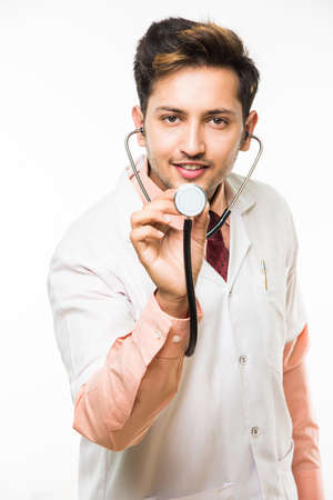 Portrait of an cheerful Indian handsome male doctor with a stethoscope around his neck, isolated over white background, selective focusの写真素材