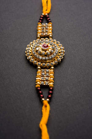 Raksha Bandhan greeting - Rakhi and gift with sweet kaju katli or mithai and rice grains & kumkum in...