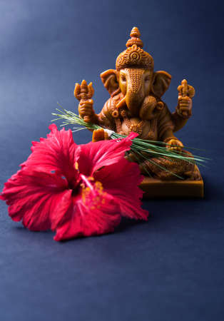 Happy Ganesh Chaturthi Greeting Card showing photograph of lord ganesha idol, pooja or puja thali, bundi laddu/modak, durva and hibiscus or jasvand flowerの写真素材