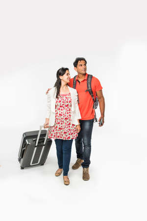 stock photo of smart Asian or Indian couple traveler with suitcase and hike bag isolated over white background, going abroad or within country, perfect shot for tours and travels companyの写真素材