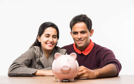 Indian electrician engineer in action with wire cutter, drilling machine etc, standing isolated over white backgroundの写真素材