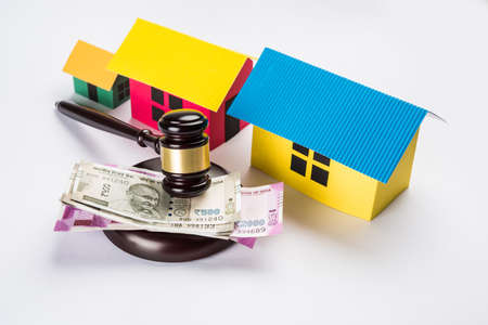 stock photo of india and real estate law, Indian law for real estate / construction company  / architects / builders or buyers showing small house model, gavel / hammer, indian currency notesの写真素材