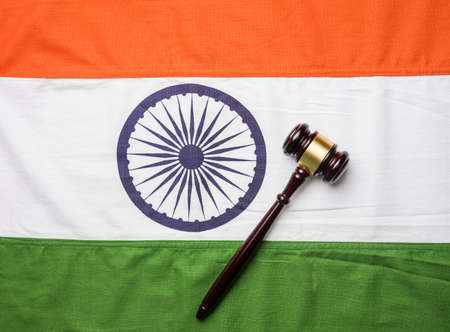 stock photo showing Indian low and jurisdiction - Indian national flag or tricolour with wooden...