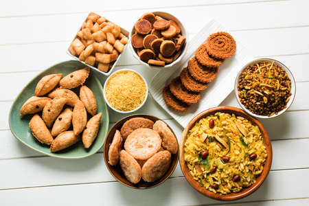 stock photo of  Diwali food or Diwali snacks or Diwali sweets like anarsa, bakarvadi, chakli, sev, bhujiya, shankar pale and chivda or chiwada, karanji, favourite indian diwali recipe, selective focusの写真素材