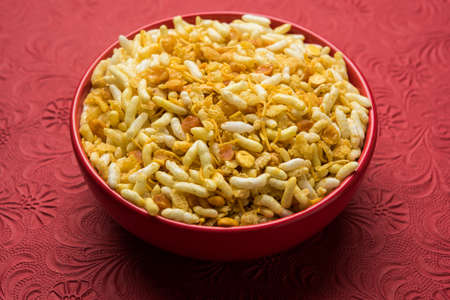 Indian traditional and popular snack poha chivda or chivada made from frying items like thin flattened rice, red chili, curry leaves, groundnuts, cashew nuts and almonds. selective focusの写真素材