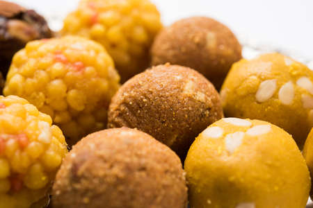 Stock photo of variety of sweet laddu or laddoo or ladu, a sweet dumpling made up of bundi, dry fruits or rava, selective focusの写真素材