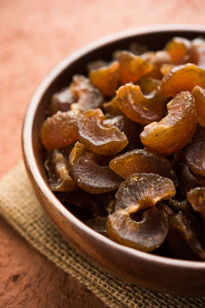 Ayurvedic Amla Candy, which is dried and salty-sweet or chatpata in taste and digestive. Served in a wooden bowl, selective focusの写真素材