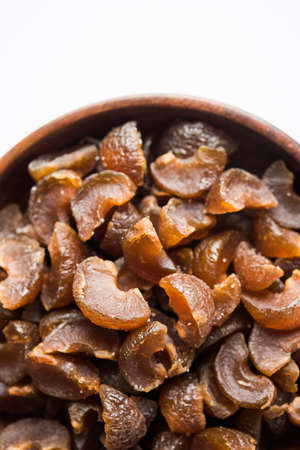 Ayurvedic Amla Candy, which is dried and salty-sweet or chatpata in taste and digestive. Served in a wooden bowl, selective focusの写真素材