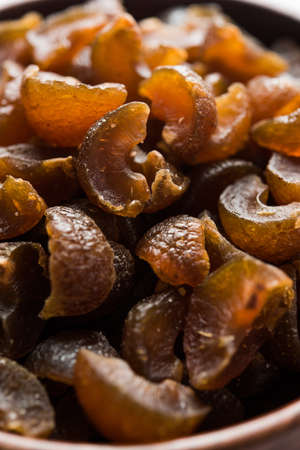 Ayurvedic Amla Candy, which is dried and salty-sweet or chatpata in taste and digestive. Served in a wooden bowl, selective focusの写真素材