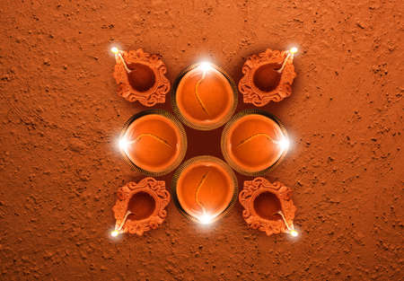 Stock photo of diwali greeting card showing top view of many illuminated diyas or oil lamps or panti forming shape of Diya with Happy Diwali textの写真素材