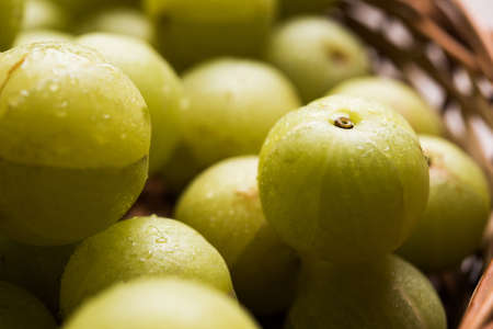 stock photo of Indian gooseberry or Amla (Phyllanthus emblica) in a cane basket, selective focus
