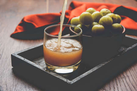 Indian fresh gooseberry juice or stock photo of Amla juice (Phyllanthus emblica) , selective focusの写真素材