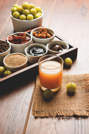 Stock photo of AmlaAvlaAavla and it's by products like chyawanprash or chyavanprash, juice, Amla supari or mouth freshner, powder, juicy or dried sweet murabba or muramba, pickle, selective focusの写真素材