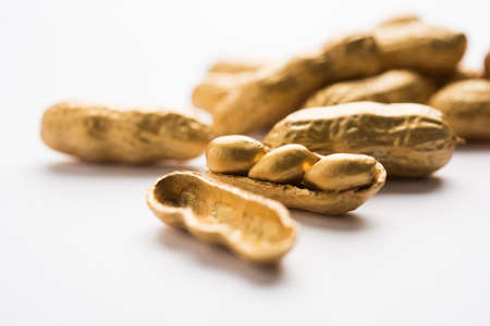 Concept of individuality, luck,value,exclusivity and better choice. Golden peanut or ground nut,...