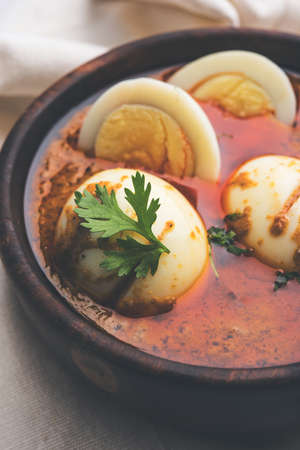 Anda Curry or Egg Curry or Egg masala gravy, indian spicy food or recipe, served with roti or naan, selective focusの写真素材