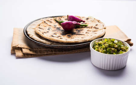 Bajra roti or Jowar Roti or Indian bread made using Bajra or Jowar, served with green chilly thecha