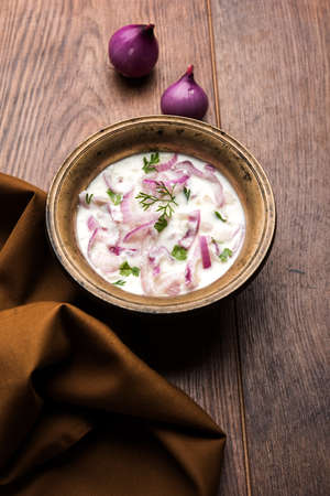 Onion Raita / pyaj or kanda Koshimbir / Indian salad is a condiment from the Indian subcontinent, made with dahi or curd together with raw or cooked vegetables like onion, tomato, green chilli and corianderの写真素材