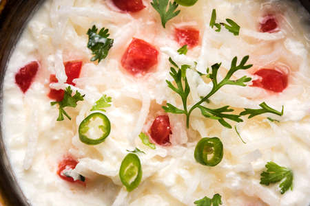 Radish Raita / daikon or Mooli Koshimbir is a condiment from the Indian subcontinent, made with dahi or curd together with raw or cooked vegetables like radish, tomato, green chilli and corianderの写真素材