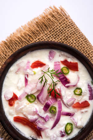 Onion Raita / pyaj or kanda Koshimbir / Indian salad is a condiment from the Indian subcontinent, made with dahi or curd together with raw or cooked vegetables like onion, tomato, green chilli and corianderの写真素材