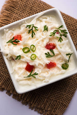 Radish Raita / daikon or Mooli Koshimbir is a condiment from the Indian subcontinent, made with dahi or curd together with raw or cooked vegetables like radish, tomato, green chilli and corianderの写真素材