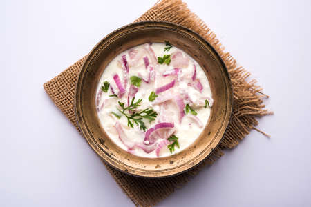 Onion Raita / pyaj or kanda Koshimbir / Indian salad is a condiment from the Indian subcontinent, made with dahi or curd together with raw or cooked vegetables like onion, tomato, green chilli and corianderの写真素材