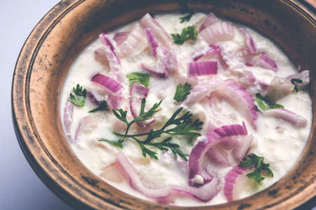 Onion Raita / pyaj or kanda Koshimbir / Indian salad is a condiment from the Indian subcontinent, made with dahi or curd together with raw or cooked vegetables like onion, tomato, green chilli and corianderの写真素材