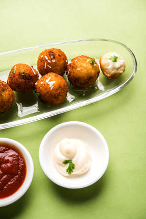 Fried potato cheese balls or croquettes with tomato ketchup. Selective focus