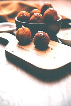 Fried potato cheese balls or croquettes with tomato ketchup. Selective focus