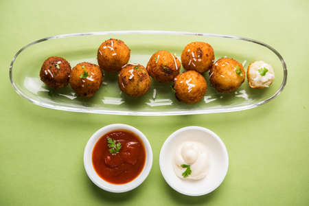 Fried potato cheese balls or croquettes with tomato ketchup. Selective focus