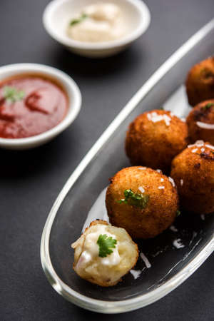 Fried potato cheese balls or croquettes with tomato ketchup. Selective focusの写真素材
