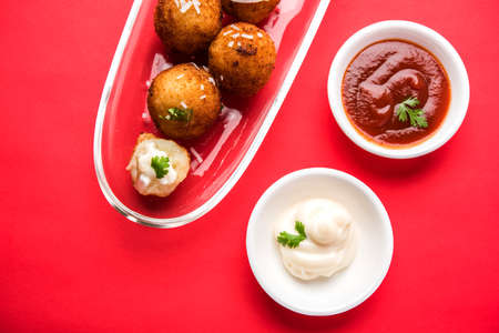 Fried potato cheese balls or croquettes with tomato ketchup. Selective focus