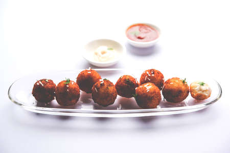 Fried potato cheese balls or croquettes with tomato ketchup. Selective focus