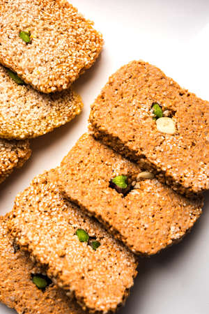 Gajak or til papdi or patti is a dry sweet cake - made of sesame seeds, ground nuts and jaggery,...