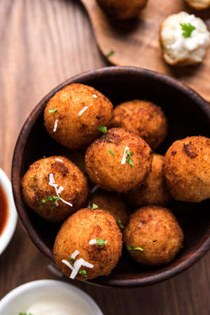 Fried potato cheese balls or croquettes with tomato ketchup. Selective focus