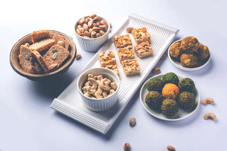 Indian sweet food group photo. Dry fruit laddu, kaju katli or kaju burfi, gajak or til papdi, rasmalai or Rasmalai, gulab jamunの写真素材