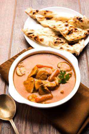 Indian mushroom curry with roti or naan or flat bread, selective focusの写真素材