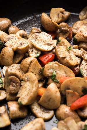 Mushroom Fry or sauteed mushroom or masharoom served in a bowl or in a frying pan over colourful backgroundの写真素材