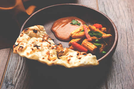Indian Baby Corn Masala or spicy Baby corn curry served with roti or naan or indian bread