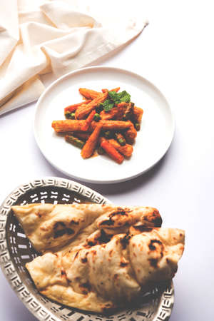 Indian Baby Corn Masala or spicy Baby corn curry served with roti or naan or indian breadの写真素材