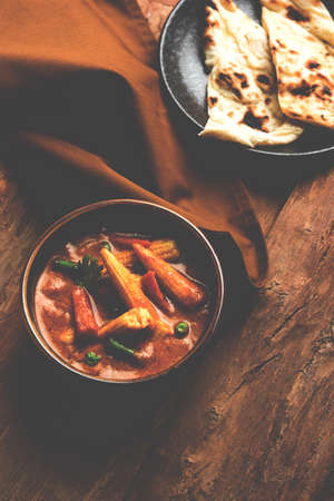 Indian Baby Corn Masala or spicy Baby corn curry served with roti or naan or indian breadの写真素材