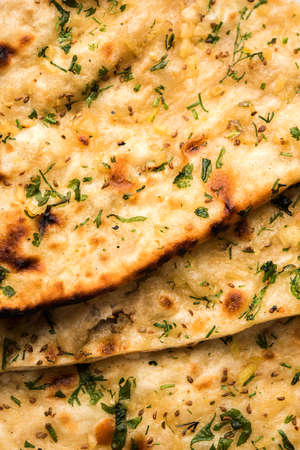 Garlic and coriander naan served in a plate, it's a type of Indian bread or roti flavoured with garlicの写真素材