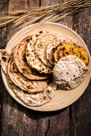 Assorted Indian Bread Basket includes chapati, tandoori roti or naan, paratha, kulcha, fulka, missi rotiの写真素材