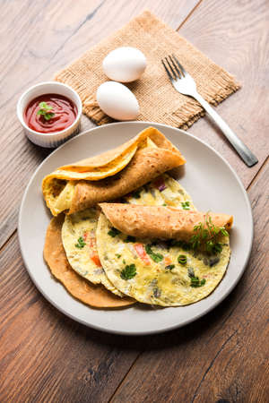 omelette / omelette chapati roll or Indian bread or roti rolled with omlet. Popular, quick and healthy recipe for kid's tiffin or lunch boxの写真素材