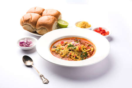 Misal Pav or misalpav, Misal Pav with Farsan. Traditional Indian spicy dish made with moth beans (match) and served with farina and breadの写真素材