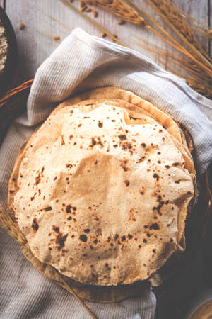 indian bread / Chapati / Fulka / Gehu Roti with wheat grains in background. It's a Healthy fiber...