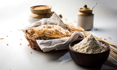 indian bread / Chapati / Fulka / Gehu Roti with wheat grains in background. It's a Healthy fiber rich traditional North/South Indian food, selective focusの写真素材