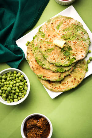 Green peas stuffed paratha or matar ka paratha, which is a traditional and popular food native to north India, made from dough of wheat flour and green peas or matar, served with mango pickleの写真素材